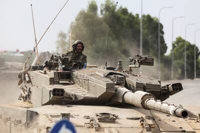 Israeli soldiers drive in a tank by Israel's border with Gaza in southern Israel. Reuters