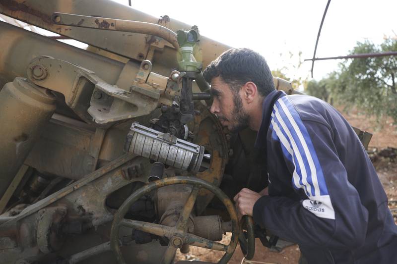 Rebels prepare to fire towards government positions in response to the attacks on Maram camp on Sunday. AP