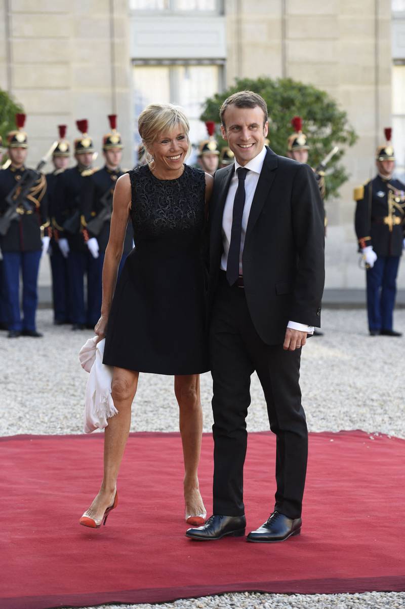 Brigitte Macron, wearing a black dress and Gianvito Rossi heels, accompanies her husband Emmanuel Macron to the Elysee Palace on June 2, 2015. AFP