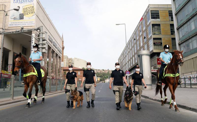 Ankara's mounted police unit officers patrol with dogs the streets in the Ulus district in Ankara, Turkey.  AFP