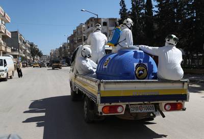 Members of the Syrian Civil Defence, also known as the "White Helmets", prepare their equipment before sterilising a hospital in Idlib on March 22, 2020. AFP