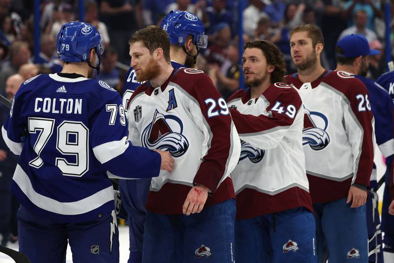 Colorado Avalanche players shake hands with Tampa Bay Lightning players after the match. AFP
