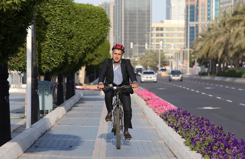 Rami Eljundi going cycles home after his day’s work in Abu Dhabi. Pawan Singh / The National