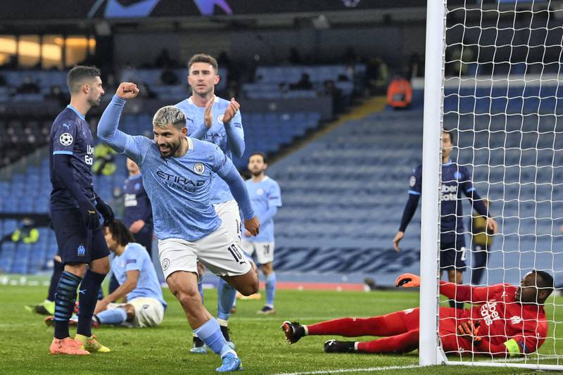 Manchester City's Argentinian striker Sergio Aguero (L) celebrates after he scores his team's second goal during the UEFA Champions League 1st round day 6 group C football match between Manchester City and Marseille at the Etihad Stadium in Manchester, north west England, on December 9, 2020. (Photo by Paul ELLIS / AFP)