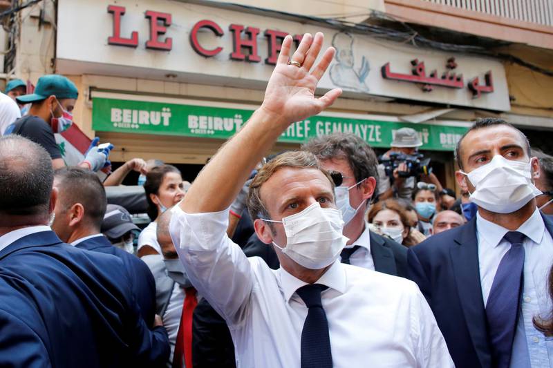 French President Emmanuel Macron waves as he visits a devastated street of Beirut, Lebanon August 6, 2020. Thibault Camus/Pool via REUTERS - RC2C8I90KFWG