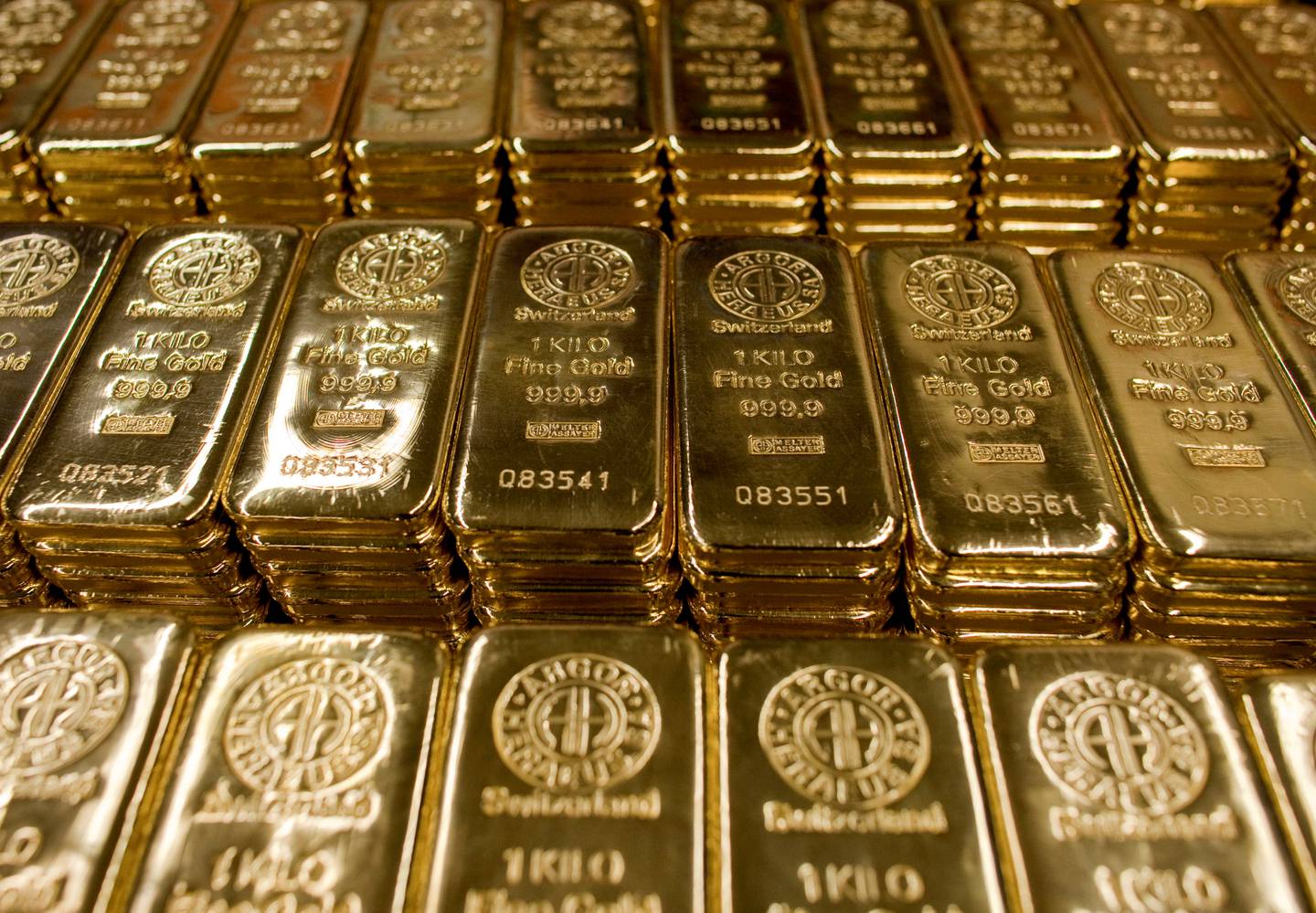 FILE PHOTO: One-kilogram gold bars are placed on a table at a factory of gold refiner and bullion maker Argor-Heraeus SA in the town of Mendrisio, southern Switzerland, March 1 2012. REUTERS / Pascal Lauener / File Photo