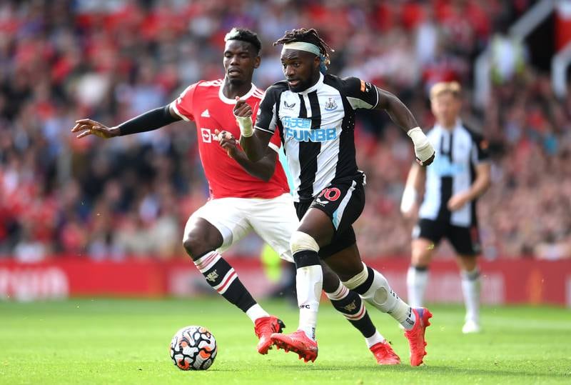 Newcastle forward Allan Saint-Maximin runs with the ball under pressure from Paul Pogba. Getty Images
