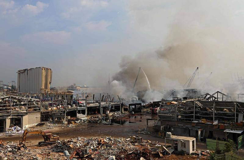 Firefighters extinguish the remaining flames at the seaport of Beirut. AFP
