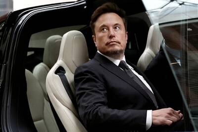 Tesla chief executive Elon Musk gets in a Tesla car as he leaves a hotel in Beijing. Reuters