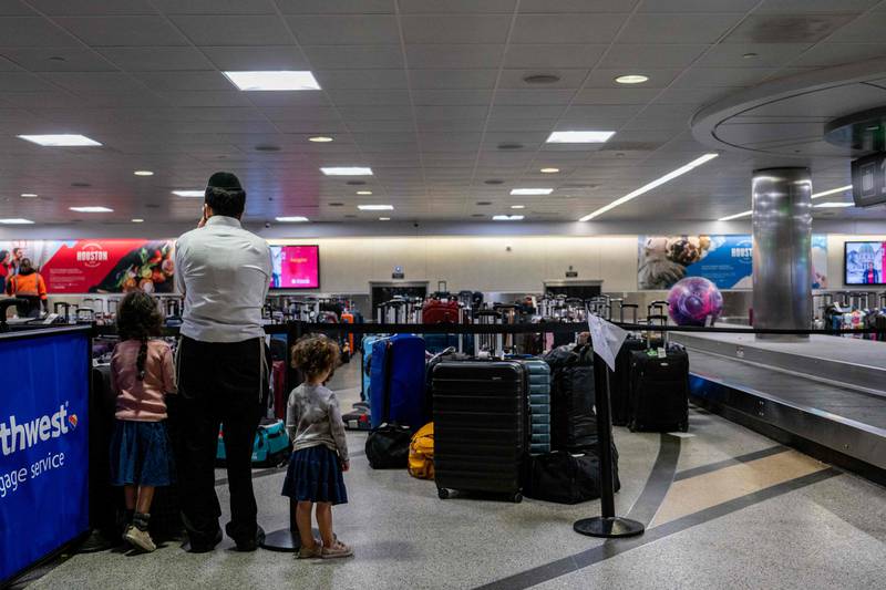 A family waits for their luggage on Wednesday in Houston, Texas.  AFP