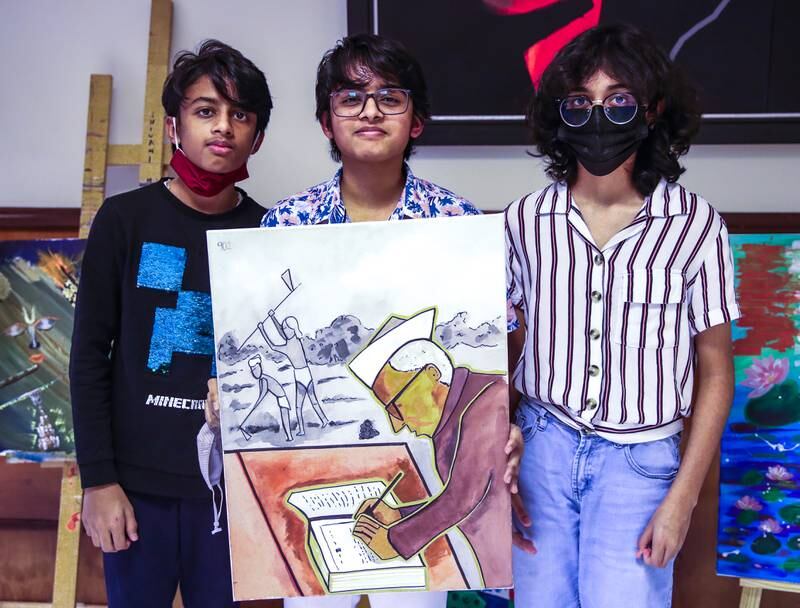 Left to right: Micah Dsouza, 12, Zoe Dsouza, 15 and
Eva Dsouza, 11 show off the artwork they created to celebrate the day. 
