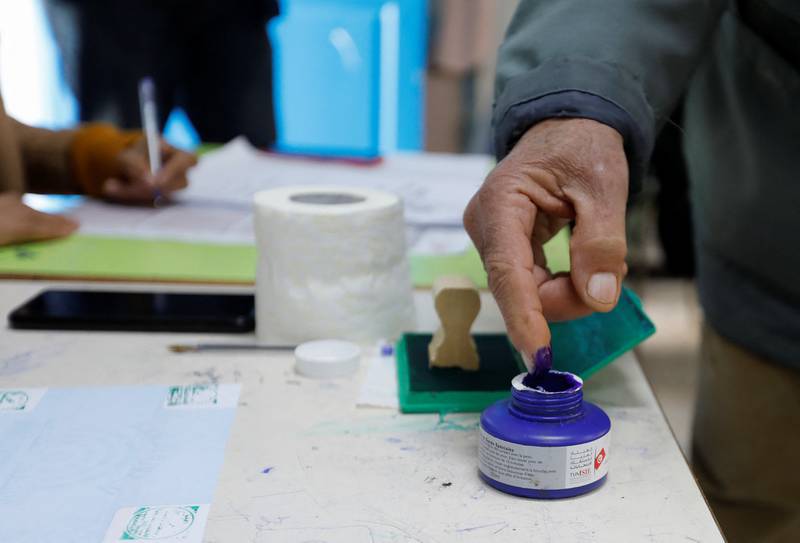 A voter dips their finger in ink as they vote at a polling station in Tunis. Reuters