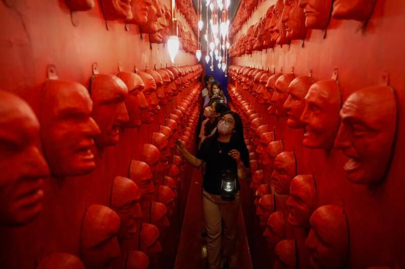 Visitors come face to face with spooky masks at Whimsical Wonderland in Quezon City, Philippines. EPA