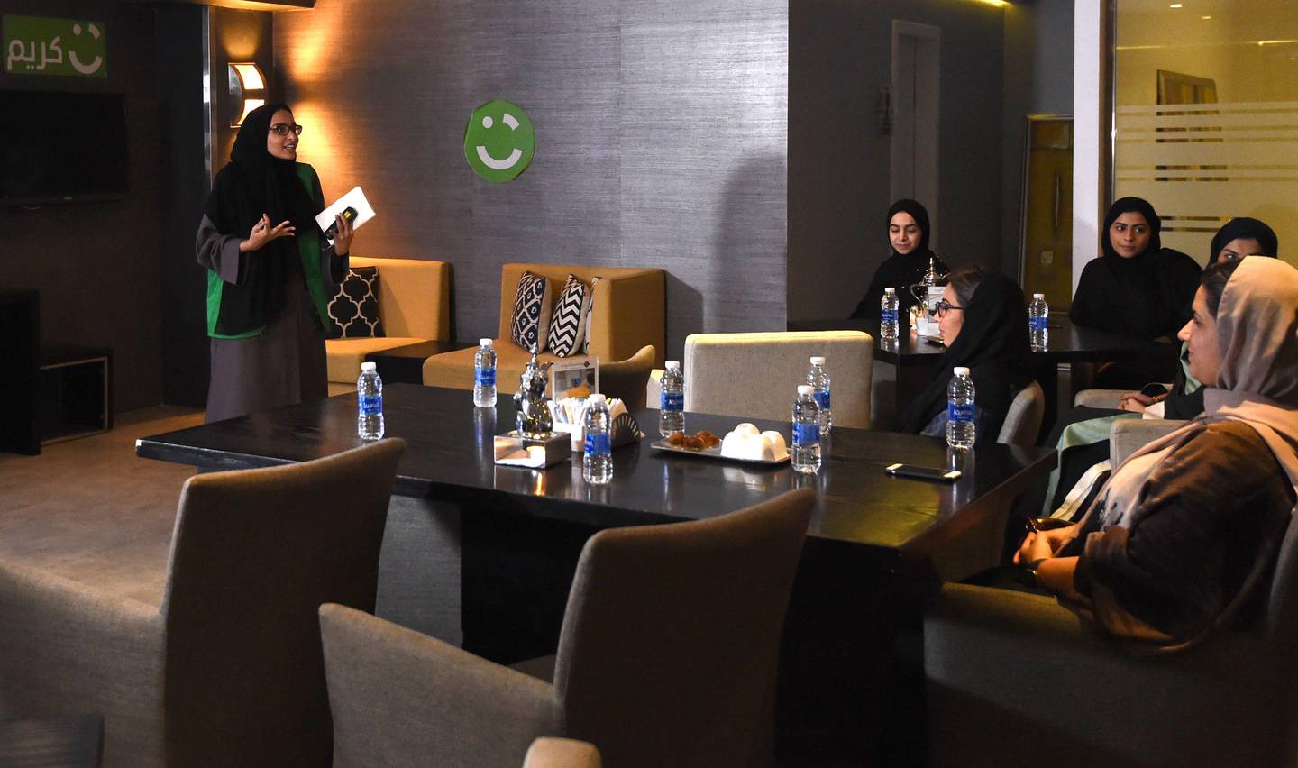 An employee of Careem, a chauffeur driven car booking service, talks during a training session for new female drivers, known in the company as "captains", at their Saudi offices in Khobar City, some 424 kilometres east of the Saudi capital of Riyadh, on October 10, 2017. 
Saudi Arabia's decision to allow women to drive had some sounding the death knell for ride-hailing apps like Careem, but its co-founder expects business to flourish and even plans to hire thousands of female drivers. / AFP PHOTO / FAYEZ NURELDINE