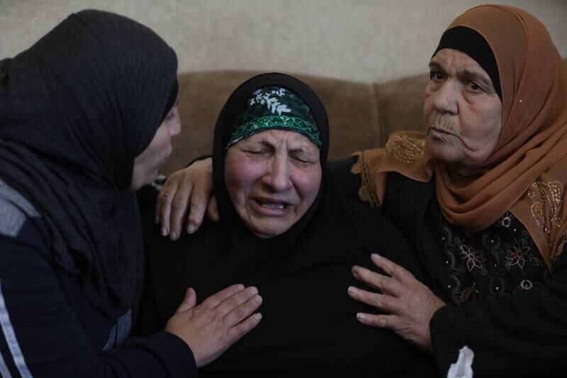 Palestinians comfort the widow of Omar Asaad during his funeral in Jiljilya village, near the West Bank city of Ramallah. EPA