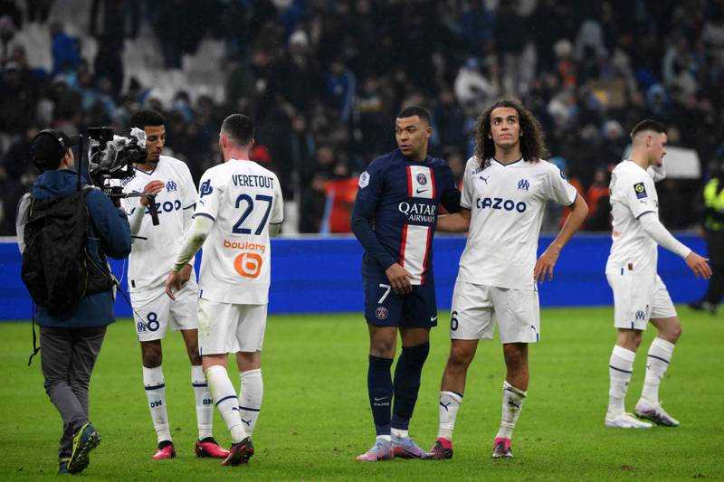 Paris Saint-Germain's French forward Kylian Mbappe consoles Marseille's French midfielder Matteo Guendouzi at the end of the match. AFP