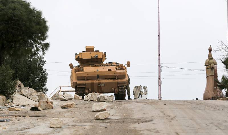 Turkish soldiers and a tank at the Ad Dana district of north-east Idlib, Syria.  EPA