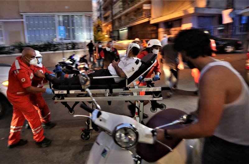 Medics shift an injured person from Najjar Hospital to another hospital in Al Hamra area in Beirut after port explosion.  EPA