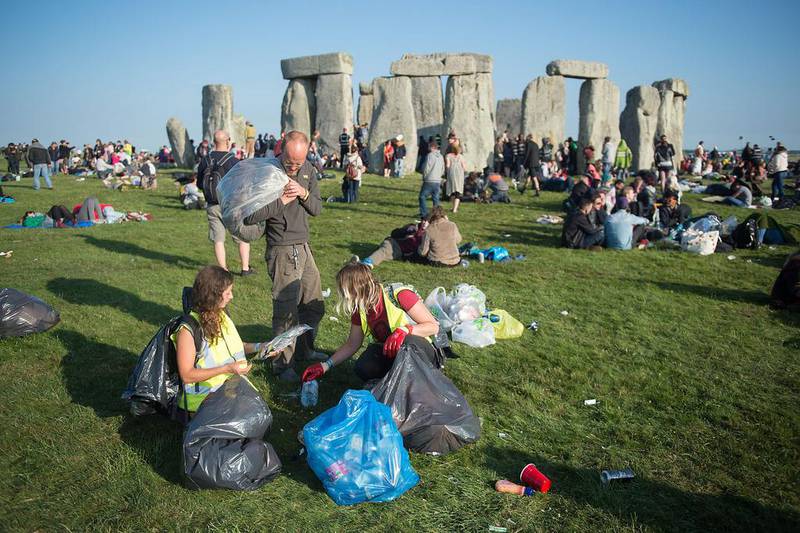People begin to clear up following the Summer Solstice sunrise at Stonehenge. Tim Ireland / Getty Images
