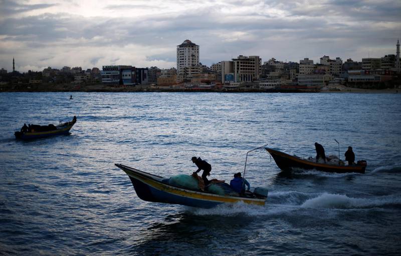 Palestinian fishermen ride boats at the seaport of Gaza City. Reuters