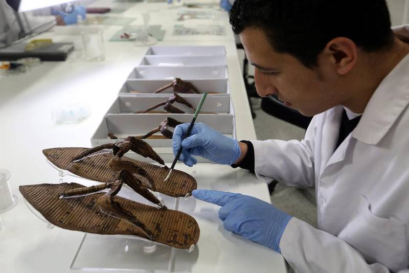 An archaeologist brushes an artefact at one of the Grand Egyptian Museum's restoration labs.