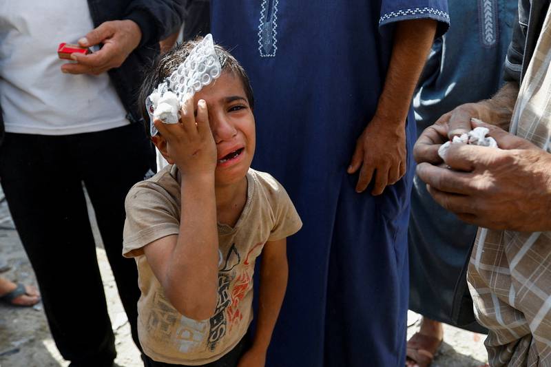 A Palestinian boy at the site of an Israeli air strike in Rafah in the Gaza Strip on October 17.  Reuters