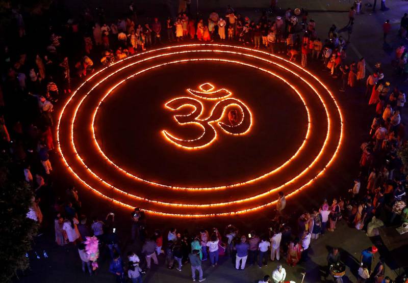 People light lamps as they make a formation of 'Om', a spiritual icon for Hindus, on the eve of Diwali, in Chandigarh, India. Reuters