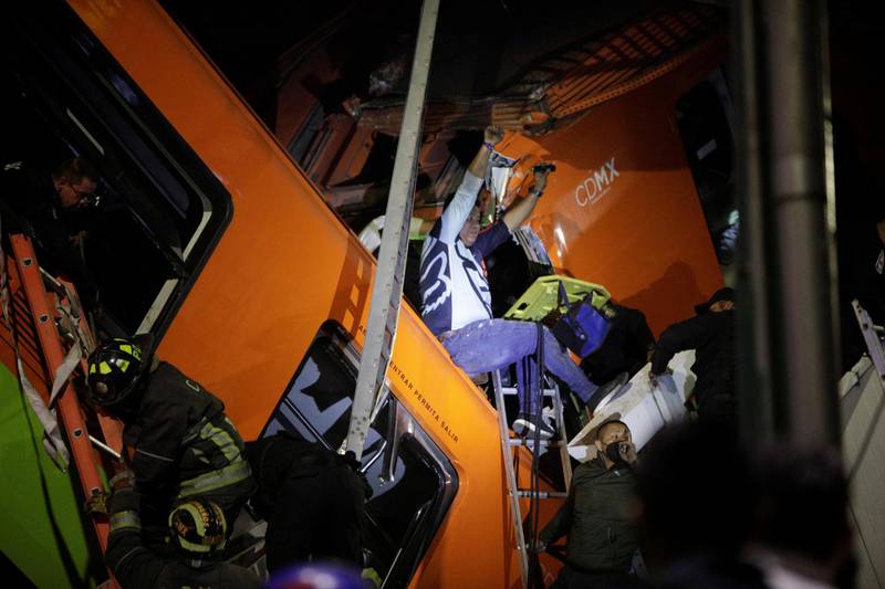 Rescuers work at a site where an overpass for a metro partially collapsed with train cars on it at Olivos station in Mexico City. Reuters