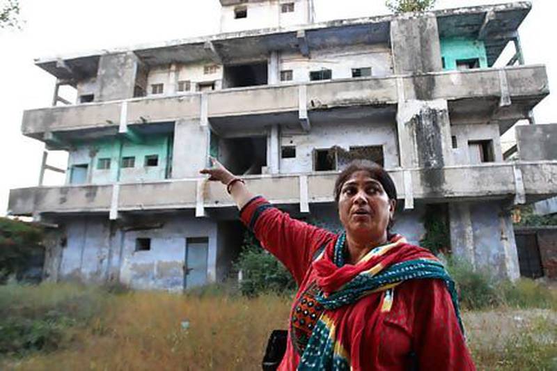 Rupa Dara Mody, a victim and witness of the 2002 riots, pointing to her flat in Ahmedabad in Gujarat state. She lost her son Ajar who was just 13 years old.