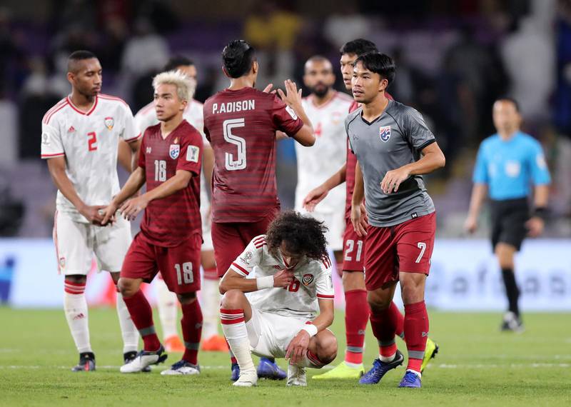 Al Ain, United Arab Emirates - January 14, 2019: Thailand celebrate as the UAE look disappointed at the end of the match after the game between UAE and Thailand in the Asian Cup 2019. Monday, January 14th, 2019 at Hazza Bin Zayed Stadium, Al Ain. Chris Whiteoak/The National