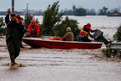 Rescuers move people to safety after Storm Daniel caused flooding in Astritsa, Greece. Reuters