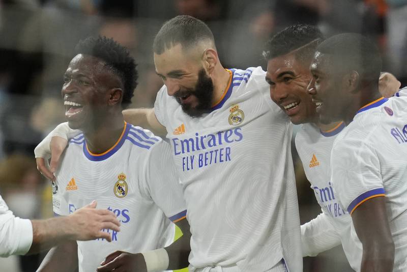 Real Madrid's Karim Benzema, second left, celebrates with teammates after scoring his side's second goal. AP Photo