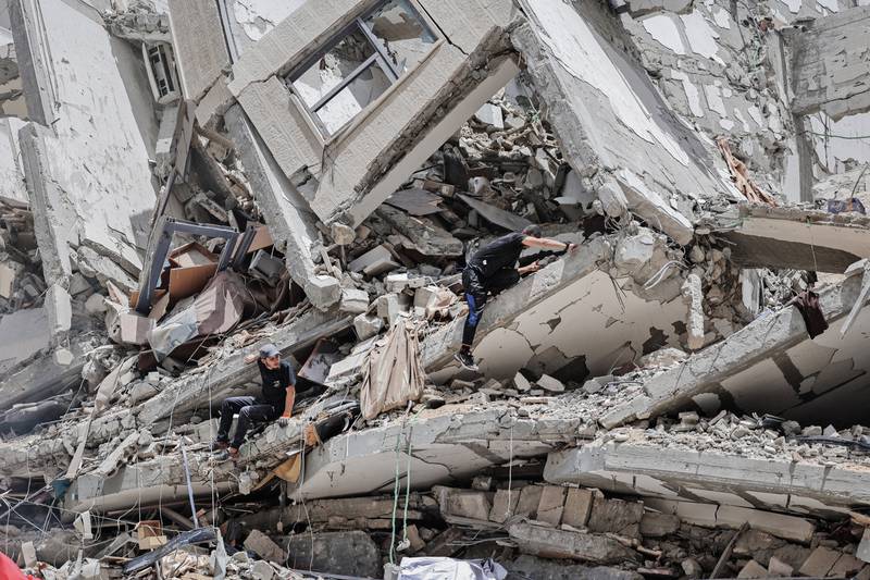 Palestinian workers clear the rubble and debris in Gaza City's Al Rimal neighbourhood. AFP