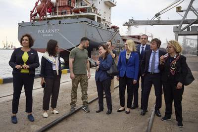 Ukrainian President Volodymyr Zelenskyy, centre, surrounded by ambassadors of different countries and UN officials, visits a port as grain is loaded on to a Turkish ship, close to Odesa. AP
