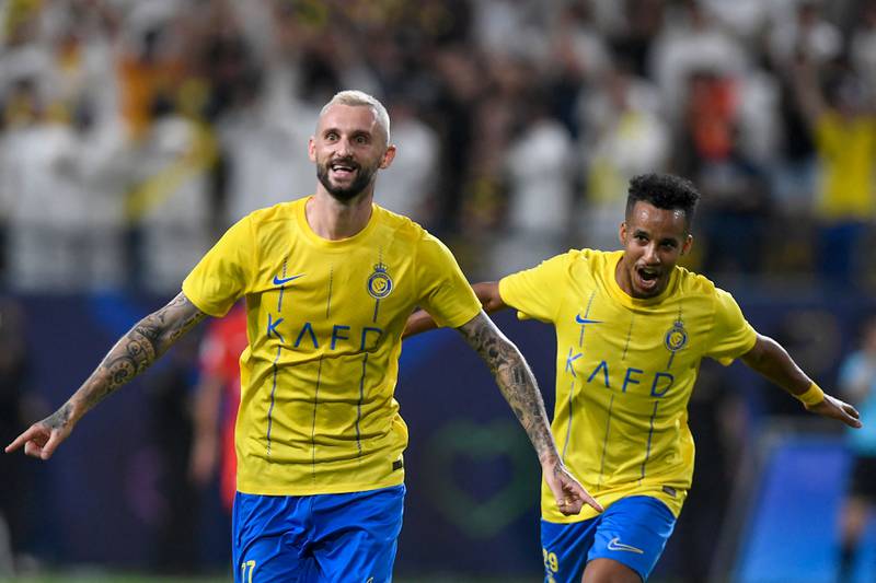 Al Nassr's Croatian midfielder Marcelo Brozovic, left, celebrates his goal during the AFC Champions League play-off against the UAE's Shabab Al Ahli in Riyadh on Tuesday. AFP