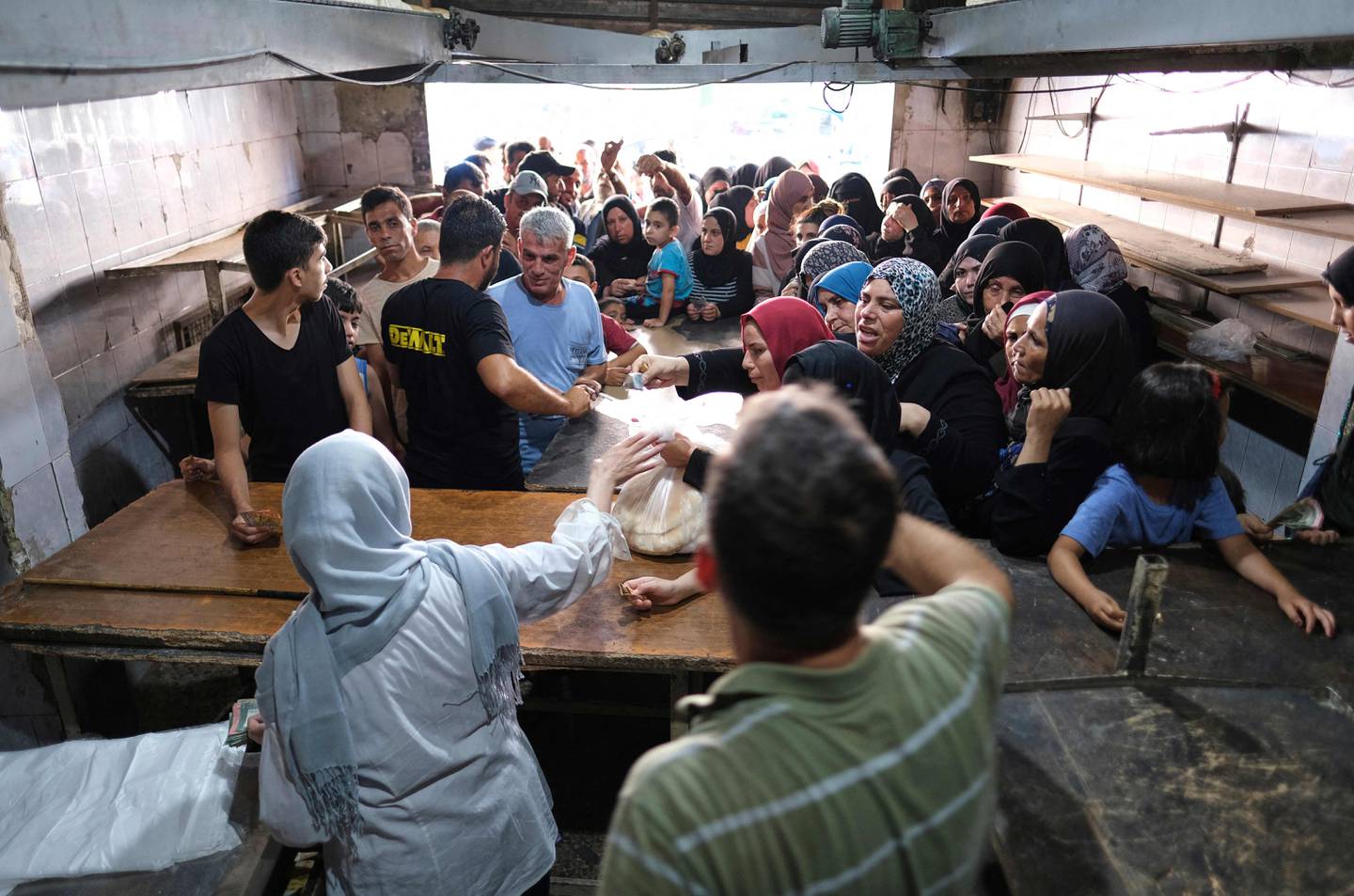 Long queues outside a bakery in north Lebanon's port city of Tripoli where people sometimes have to wait for hours for a bag of subsidised Arabic bread. AFP