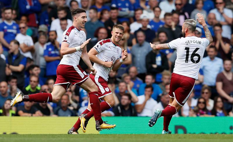 Burnley's Stephen Ward, left, celebrates scoring a goal during the English Premier League soccer match between Chelsea and Burnley at Stamford Bridge stadium in London, Saturday, Aug. 12, 2017. (AP Photo/Kirsty Wigglesworth)