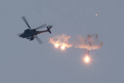 An Apache helicopter fires flares, seen from Sderot in southern Israel, close to the border with Gaza. Reuters
