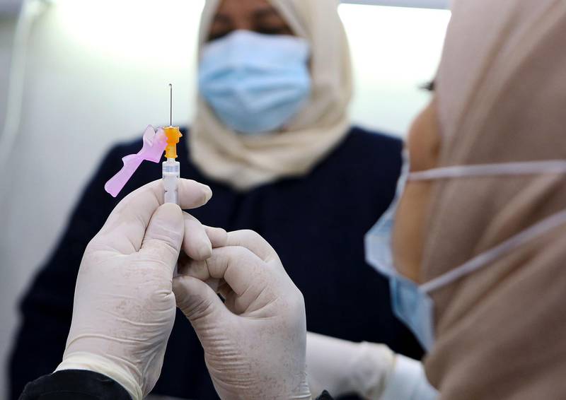 A medic prepares a Pfizer-BioTech Covid-19 vaccine injection in the capital Kuwait City. AFP