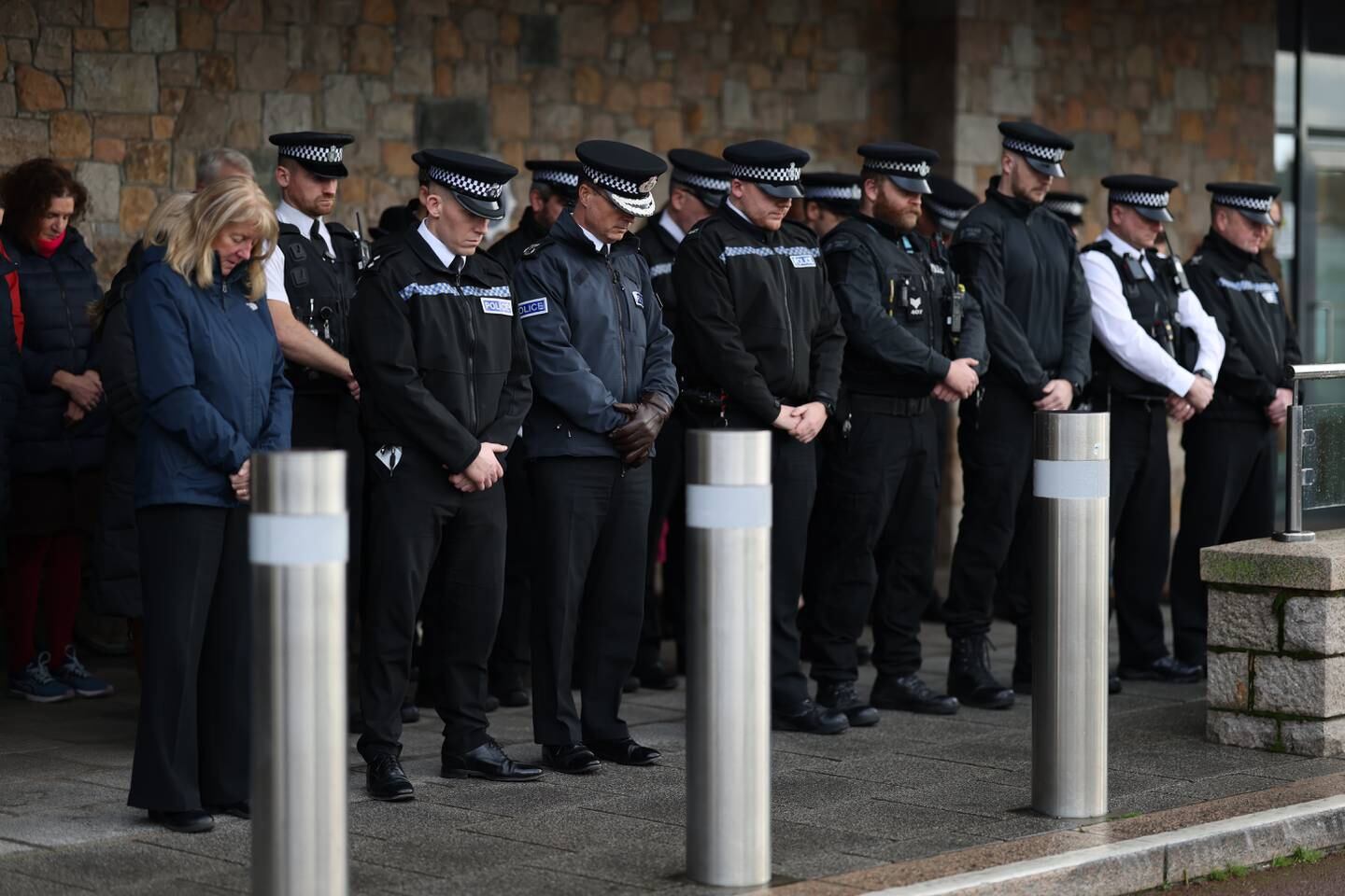 Police officers observe a minute of silence outside the States of Jersey Police headquarters. Getty Images