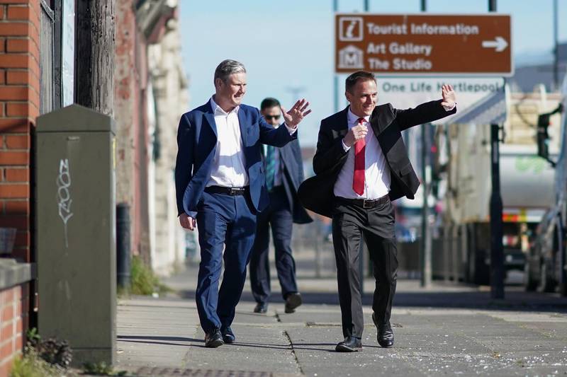 HARTLEPOOL, ENGLAND - APRIL 23: Labour Party leader Sir Kier Starmer (L) and Dr Paul Williams, Labour Party candidate for Hartlepool wave at motorists as they arrive for a visit to the Cameronâ€™s brewery in Hartlepool on April 23, 2021 in Hartlepool, England. The visit comes as the Labour Party campaigns in the town ahead of the May 6 by-election. (Photo by Ian Forsyth - WPA Pool /Getty Images)
