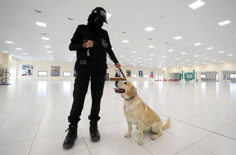 Van Cleaf, a police dog, aged 8, with his handler Noura Yaqoub, a first corporal officer. All photos: Chris Whiteoak / The National