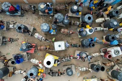 Palestinians collect water with their carts from a water desalination plant, amid water shortages. Reuters