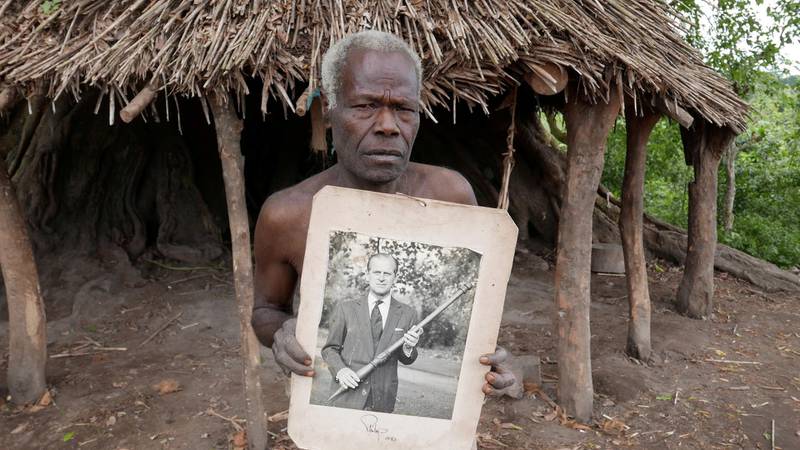 A village elder from Tanna island, Vanuatu, in the South Pacific, holds a picture of Britain's Prince Philip, who died on Friday. He is worshiped as a deity in the village of Younanen. Reuters
