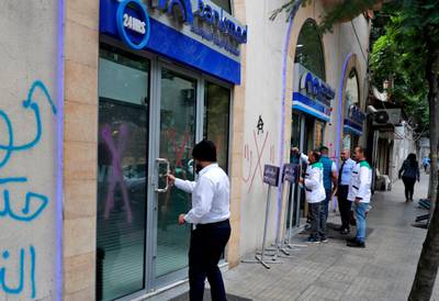 A Lebanese man enters a bank in Beirut on November 1, 2019.  AFP