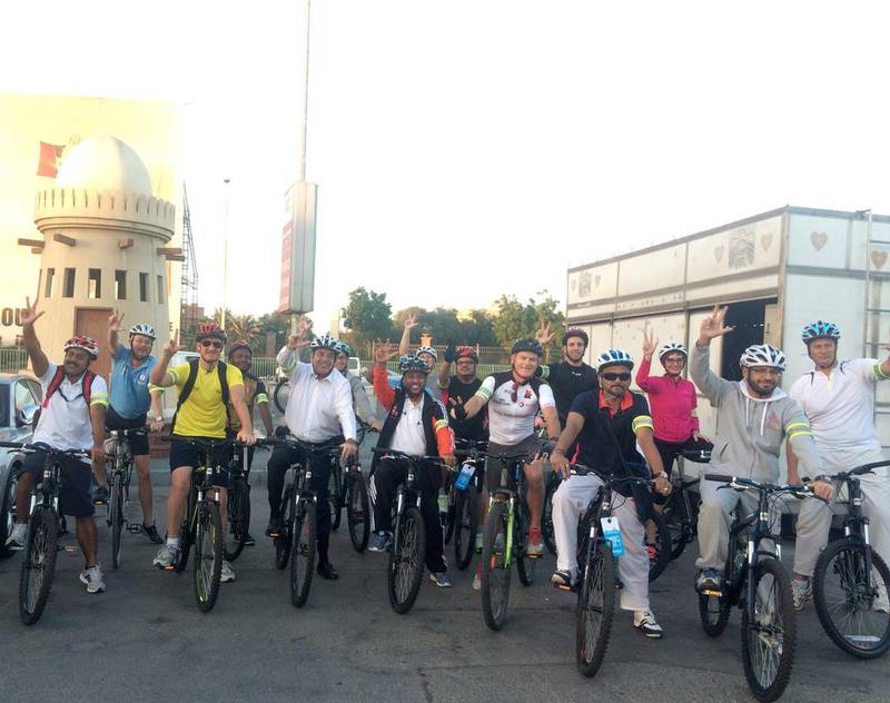 Cyclists from Total get ready to cycle into work. Mona Al Marzooqi / The National