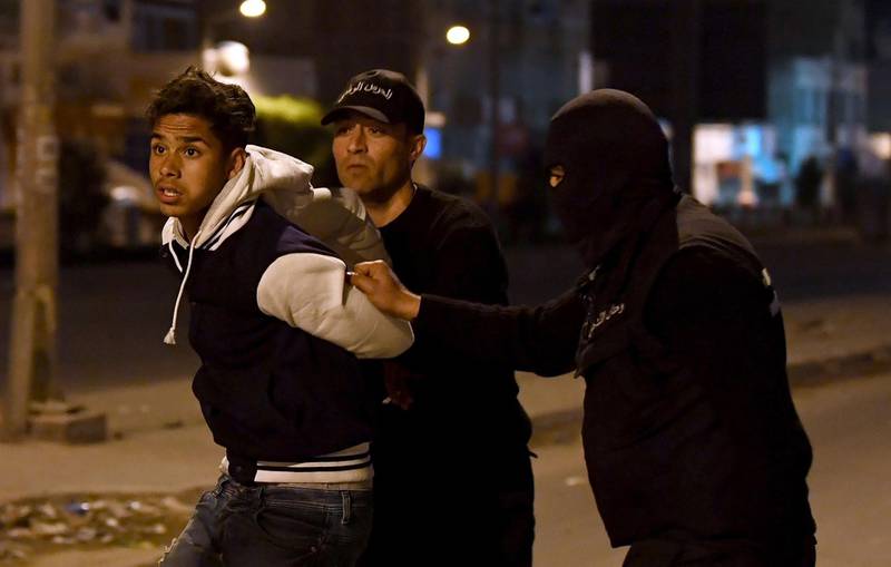 Tunisian security forces detain a protester in Ettadhamen. Fethi Belaid / AFP Photo