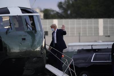 US President Donald Trump wears a protective mask while boarding Marine One outside Walter Reed National Military Medical Centre in Bethesda, Maryland. Bloomberg