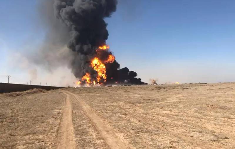 In this still image taken from video, smoke rises from fuel tankers at the Islam Qala border with Iran, in Herat Province, west  of Kabul, Afghanistan.  A fuel tanker exploded Saturday at the Islam Qala crossing in Afghanistan's western Herat province on the Iranian border, injuring at least seven people and causing a massive fire that consumed more than 500 trucks carrying natural gas and fuel, according to Afghan officials and Iranian state media. AP
