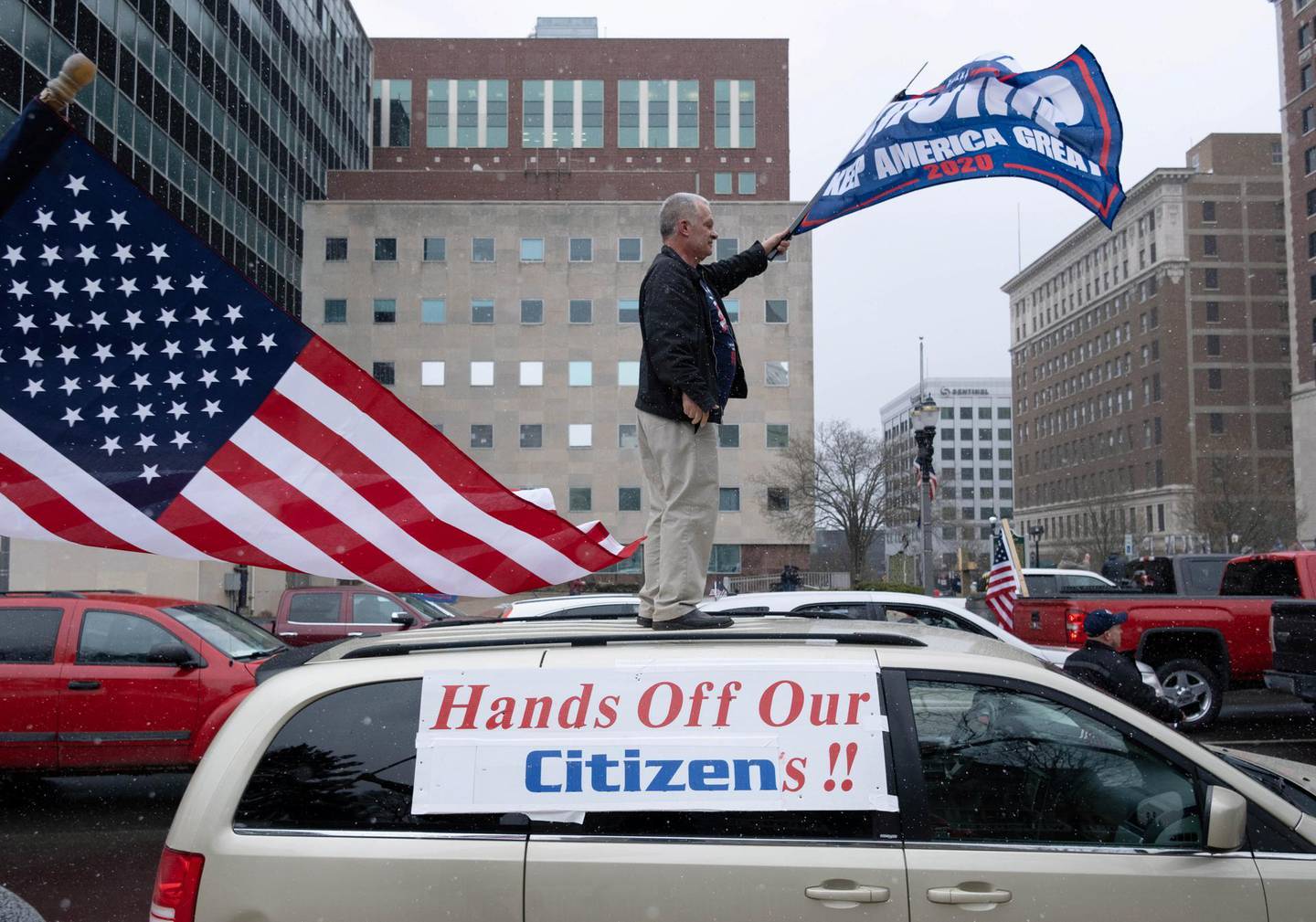Supporters of the Michigan Conservative Coalition protest against the state's extended stay-at-home order, amid the spread of the coronavirus disease (COVID-19), at the Capitol building in Lansing, Michigan, U.S. April 15, 2020. REUTERS/Seth Herald     TPX IMAGES OF THE DAY
